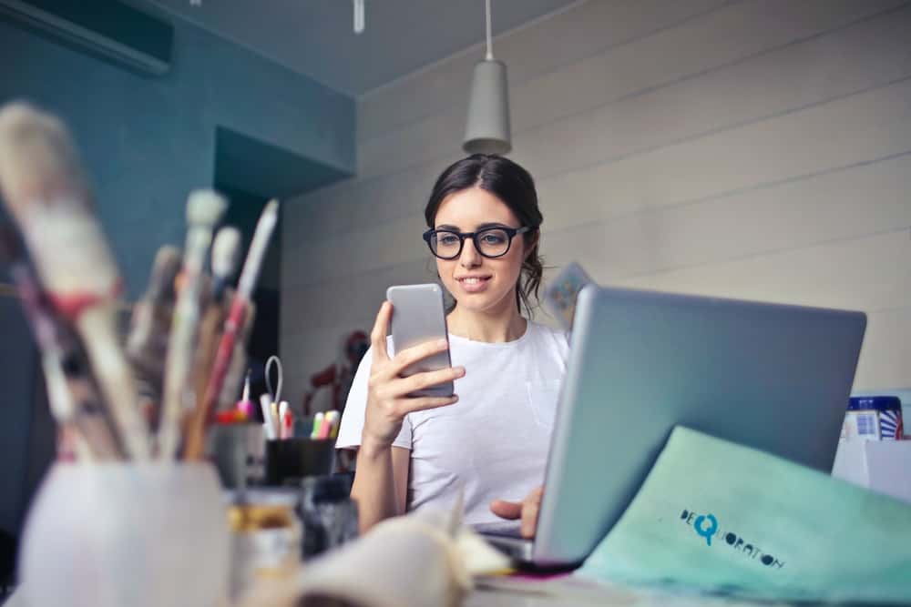 A woman checks her Amazon ad campaigns on her phone