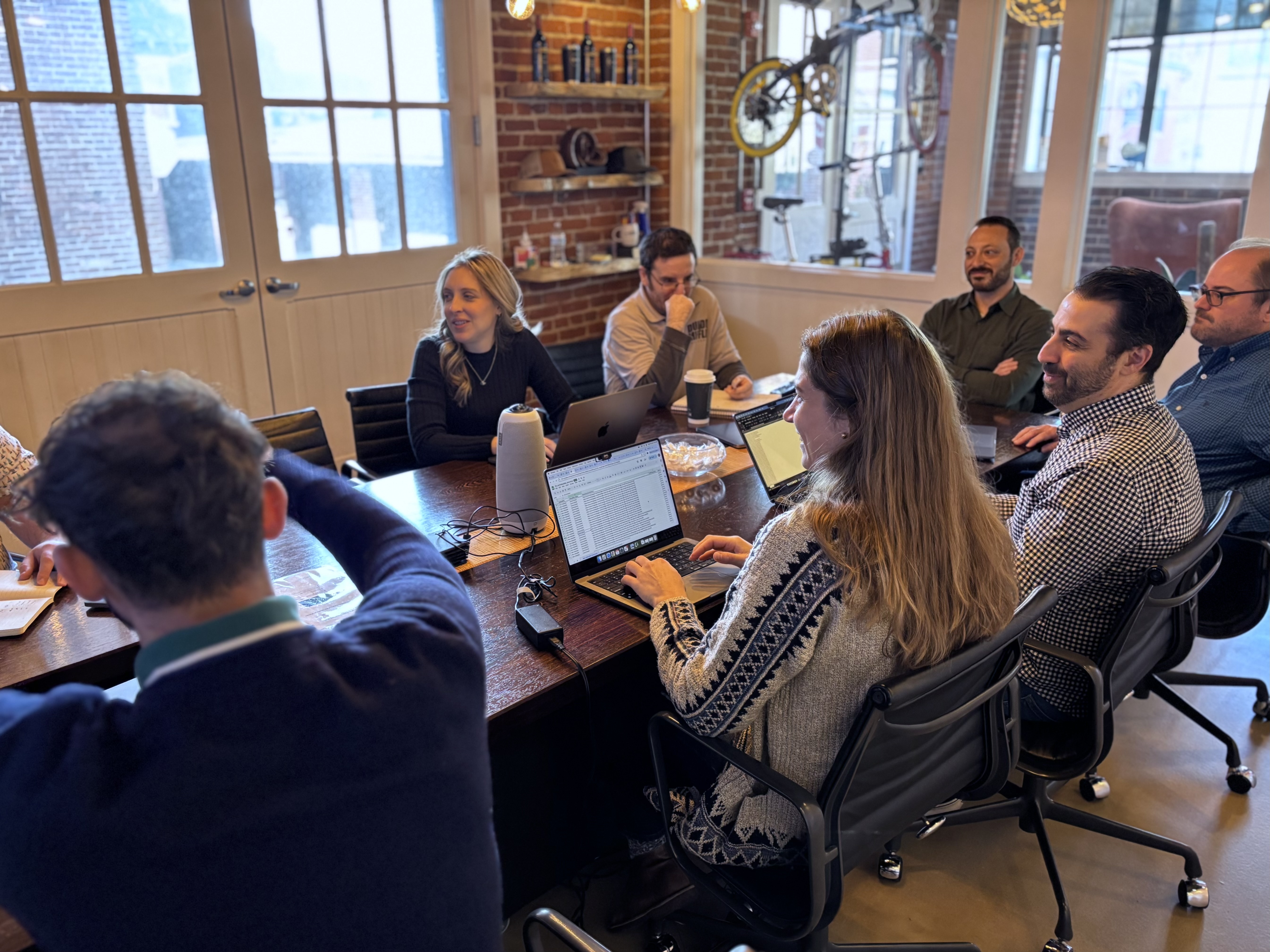 Group of People Collaborating and Talking Around Meeting Table